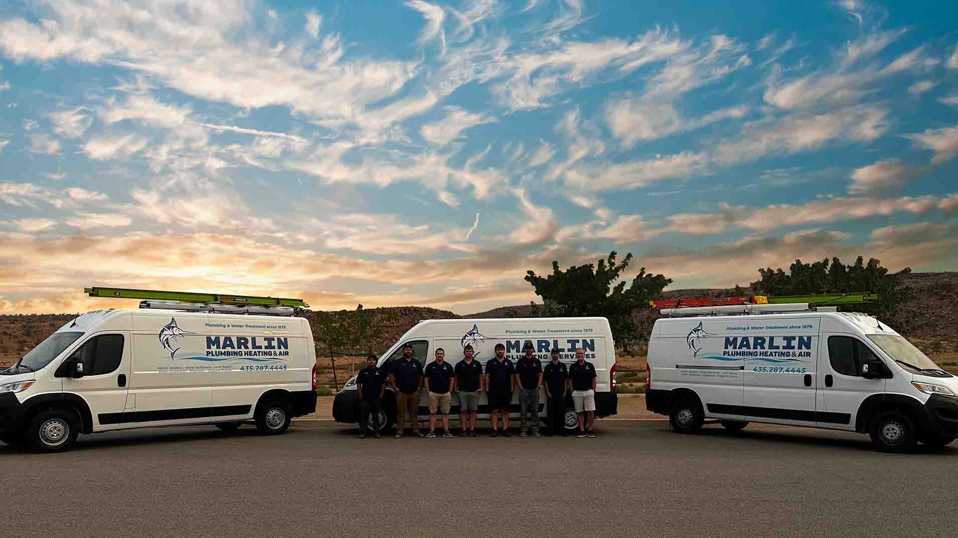 Marlin Plumbing team with branded service vans